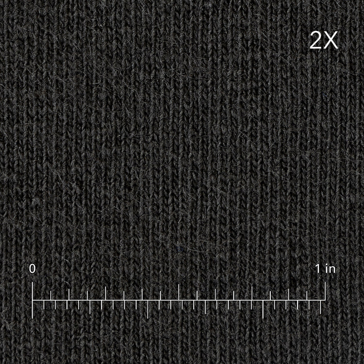 Textured black fabric with a measurement scale at the bottom right corner